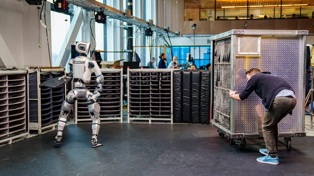 An engineer moves a target container to test Atlas's ability to adapt on to changes in the environment